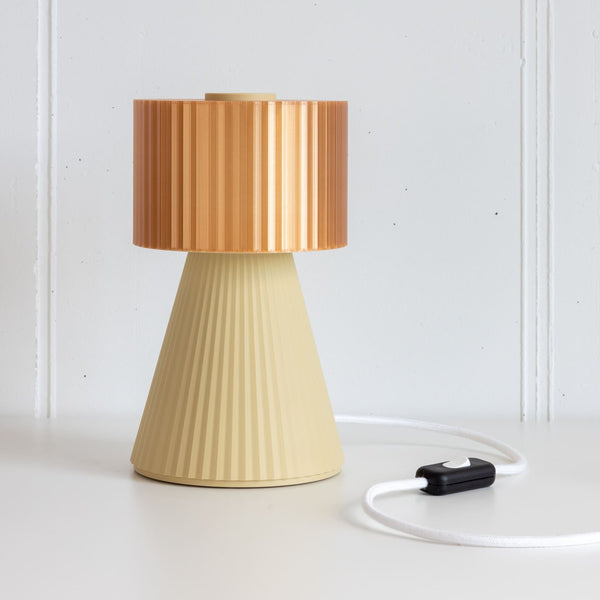 Lustra Plissé table lamp in Apricot Beige on white background with cable